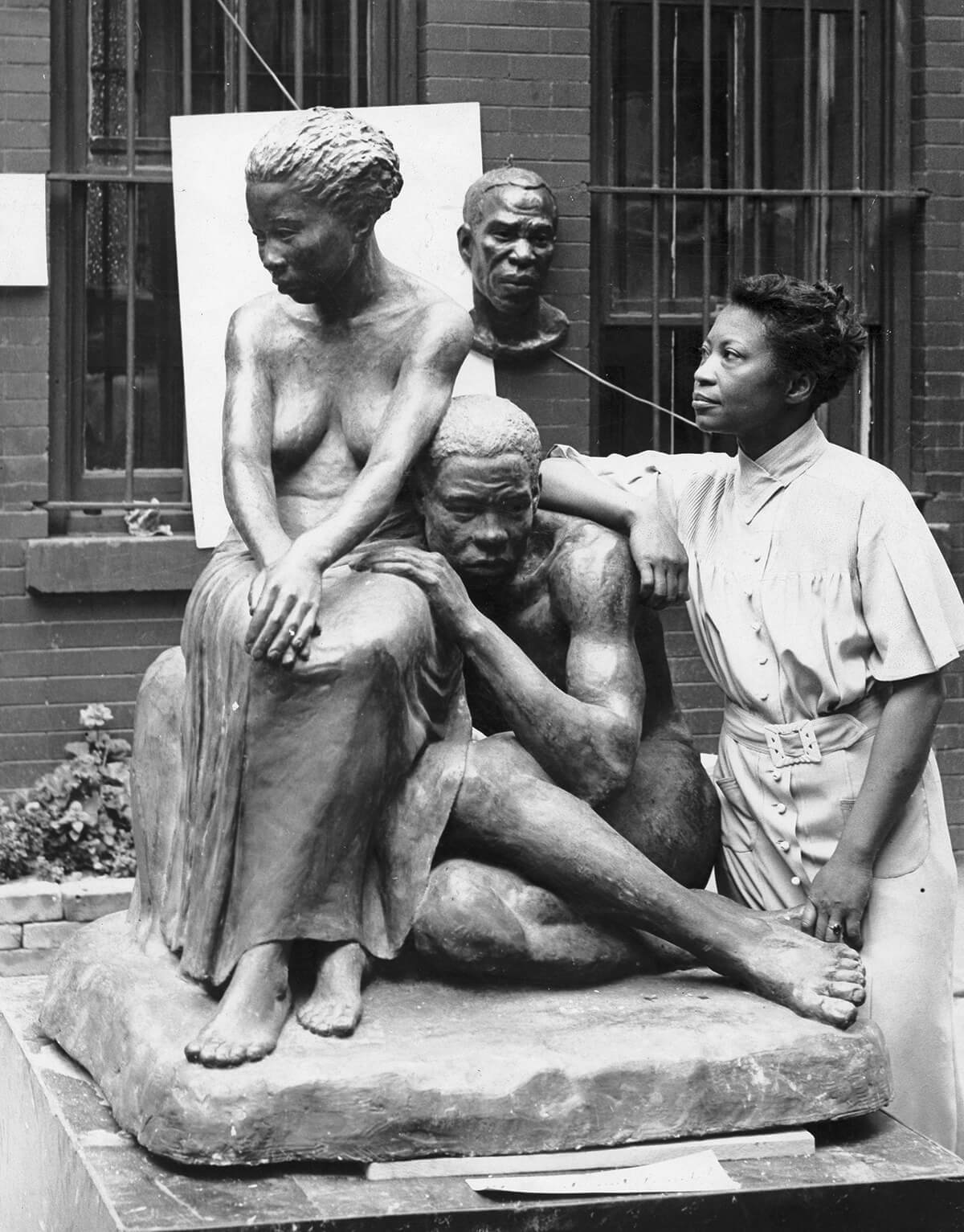 Augusta Savage with two of her statuettes, entitled “Susie Q” and Truckin’”